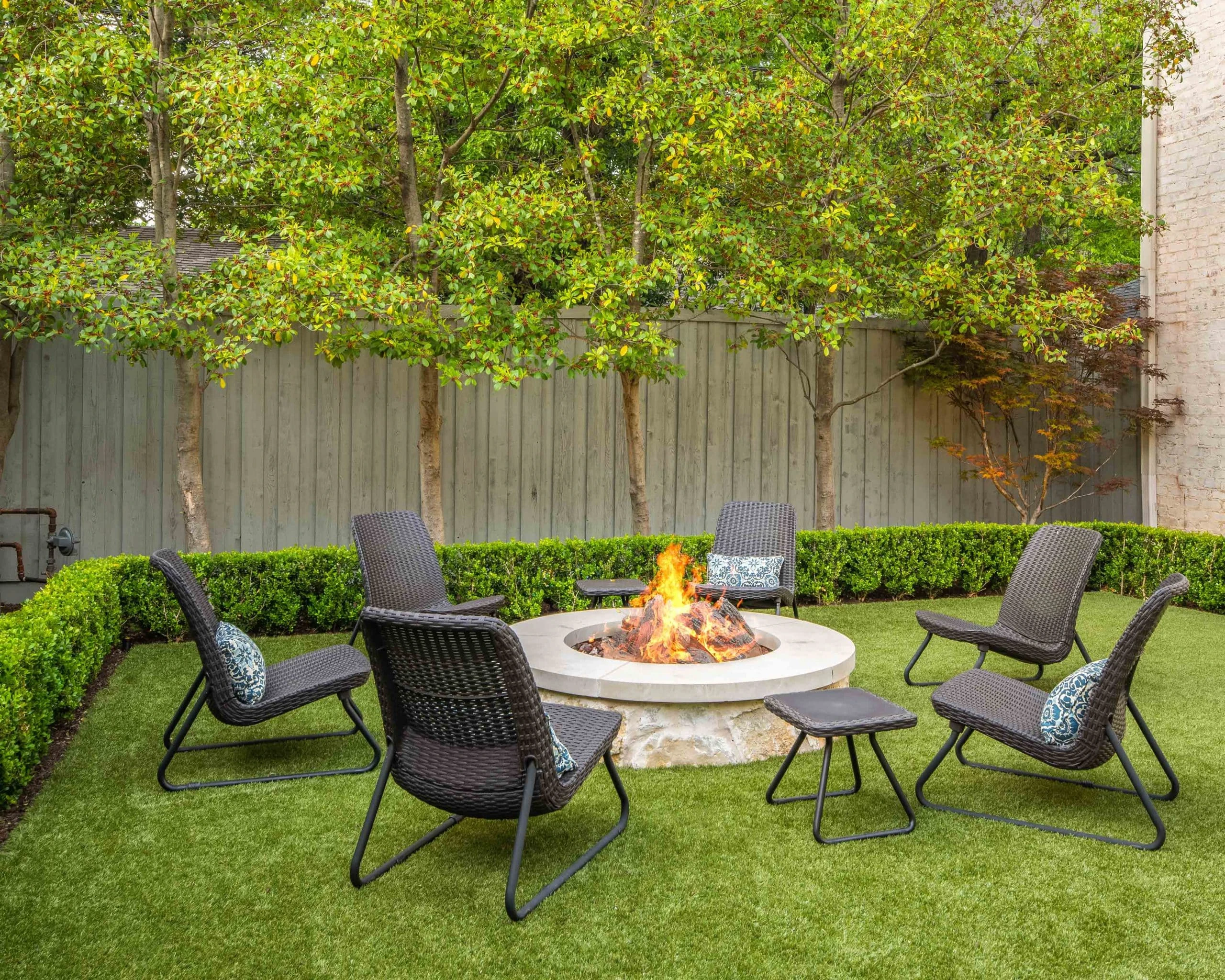 Woodstock GA outdoor living space with fire feature and lighting at night